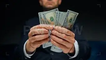 man counting us dollar bills PREVIEW 1 https://dotoman.ir/wp-content/uploads/2023/09/logo-5.jpg دوتومن، تخصصی ترین مارکت تولید محتوا در ایران